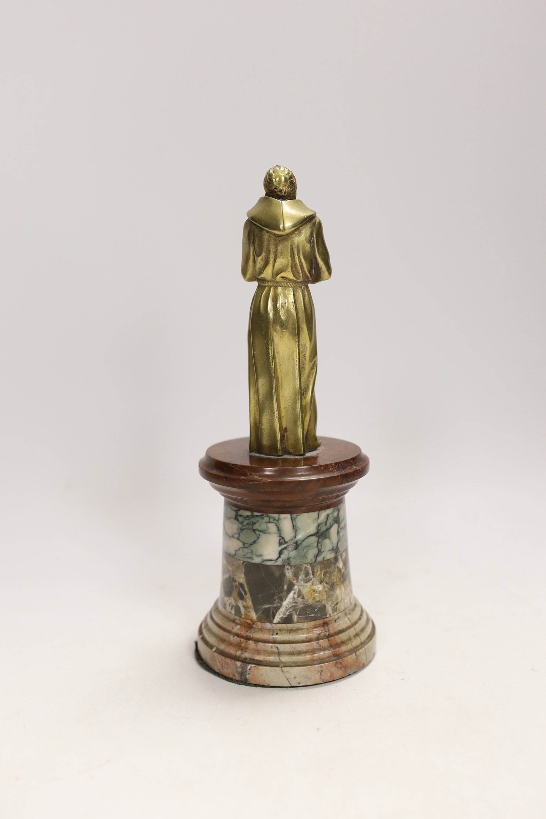 A 19th century gilt bronze of a monk on a specimen marble base, comprising four different marble strata, 20cm